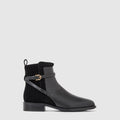 Nettie ankle boot in black leather with a criss-cross buckle